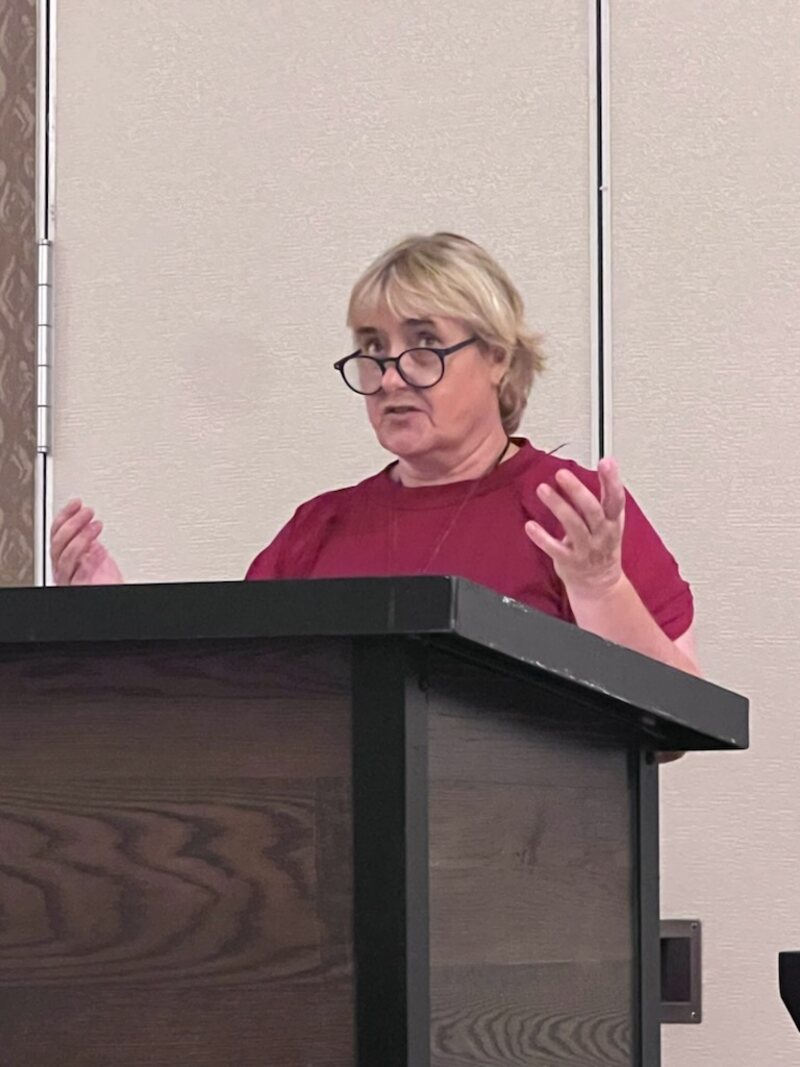 Nancy Solook, CHt, founder of Legacy Hypnosis Academy, speaking at a lectern